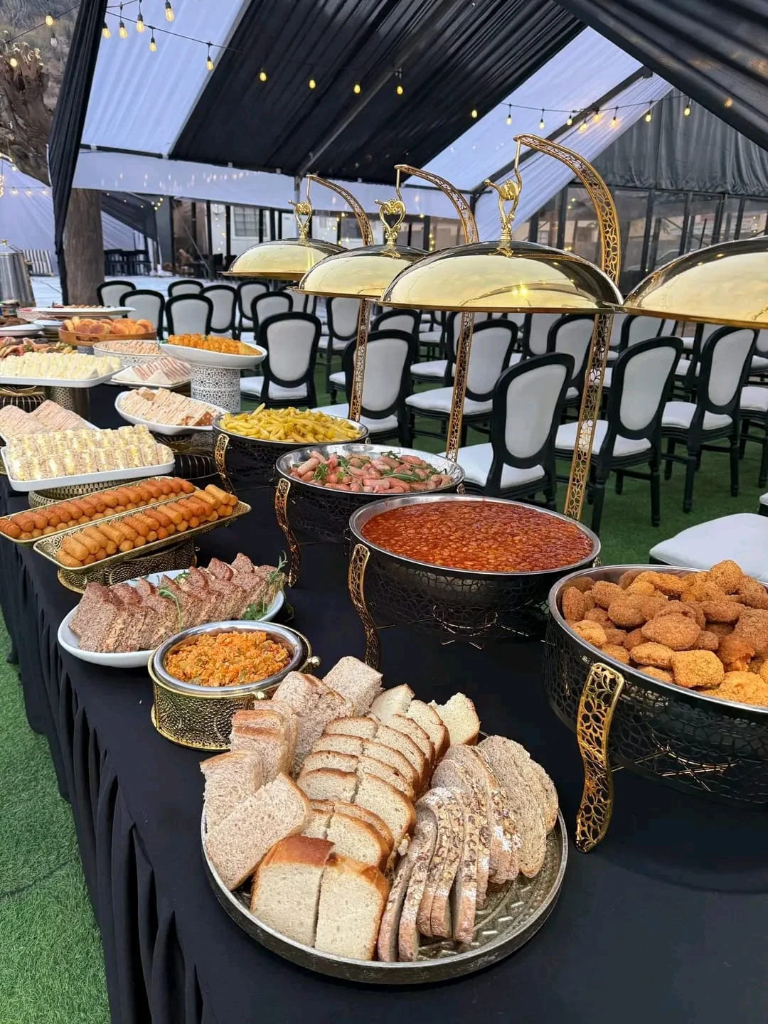 Outdoor celebration table set with warm-toned linens and glassware